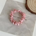 Pink silk scrunchie hair tie with glossy finish on a minimalist textured card background - Solid Pink