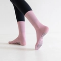 Close-up of pink mid-calf yoga socks with grey silicone non-slip dots on the sole - One Size / Pink