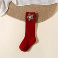 Detail of red knit knee-high baby socks with floral fabric flower and pearl accents - Xs 0-1 / Red