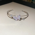 Detail of double-layer butterfly bangle with pink and white zircon stone inlay - Silver
