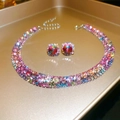 Close-up of a luxury vintage jewelry set featuring vibrant teardrop rhinestones on a gold tray - Pink Blue 2-Piece Set