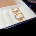 Detail of gold hoop earrings with irregular pavé-set cubic zirconia in a jewelry box - Gold Hoop Earrings / Gold