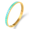 Detailed macro of gold-plated stainless steel bangle with sky blue enamel and polka dots - Gold with Blue Enamel and Gold Dots