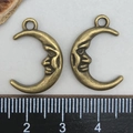 Vintage bronze moon face charm pendant shown with ruler measurement on white background - Antique Bronze Moon Face Pendant (15x22mm)