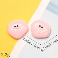 Macro shot of two pink resin cartoon shells with eyes, showing detailed dimensions 2.1x1.9cm - Shell with Eyes