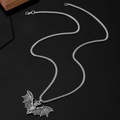 Detailed macro shot of silver punk bat pendant with textured wings and square box chain - Detailed Bat Style (0757)