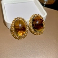 Close-up of amber oval resin earrings with crystal halo and gold-plated metal base - Gold Brown Oval Gem Style (82#)