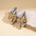 Detailed macro view of silver wavy stud earrings featuring elegant gold bow accents - Silver