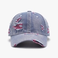 Distressed blue denim baseball cap with vintage frayed holes and pink inner lining accents - Medium Blue Denim with Pink Stitching