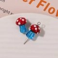 Macro shot of red glass mushrooms with white polka dots and blue stems for jewelry DIY - No.12 (Red Cap White Dot Blue Stem)