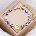 Golden Evil Eye bracelet with blue beads and letter Q charm on jewelry gift box - Letter Q