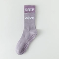 Purple knitted yoga socks with white KEEP ALIVE text and non-slip silicone grip soles - Purple