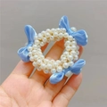 Hand holding a cute pearl hair tie for girls featuring a blue ribbon bow detail - Blue Bow Pearl Hair Tie