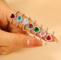 Stack of 7 heart-shaped vintage rings in assorted colors on model's finger - Heart Gemstone Eternity Ring Set (7Pcs) (25 合金爱心戒指7个)
