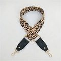 Detail of adjustable leopard print bag strap with gold metal hooks and black leather ends - Rivet Leather