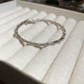 Detail of silver bamboo style bracelet with zircon accents on soft velvet tray - Bamboo Bangle / Silver