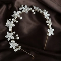 Close-up of pearl flower headband with gold wire detailing on dark silk fabric - Pearl Gold