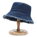 Deep blue denim bucket hat with distressed frayed edges on a vintage wooden stand - Washed Frayed Edge Blue