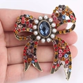 Spilla a fiocco vintage in bronzo con strass multicolore e perle su sfondo bianco - Stile Pietra Centrale Blu (b8 - 6 - 7776)