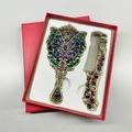 Detail showing vintage peacock metal mirror and comb set inside a red textured gift box - Butterfly / Bronze