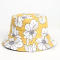 Detailed close-up of yellow floral bucket hat featuring white hand-painted flower patterns - Amber White