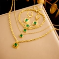 Gold plated stainless steel jewelry set with green square stones on a display stand - Necklace Earrings Bracelet Set (N2468 E6086 B1349)