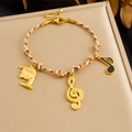 Gold braided bracelet with musical horn and note pendants on beige leather box - Music Theme Brown White Rope Bracelet (B1789)