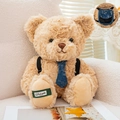 Light brown plush teddy bear with navy denim tie and miniature backpack accessory - Tan / 21cm