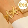 Starfish motif open bangle in matte gold finish for a tropical ocean-inspired look - Stereo Starfish Connected (DZ009)