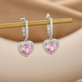 Macro shot of silver heart earrings with pink gems and white zircon micro-inlay - Silver Pink
