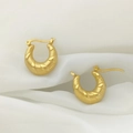 Macro shot of gold U-shaped earrings with fine spiral texture on white silk background - Spiral Horn Style (XL1464-55)