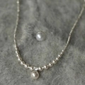 Elegant pearl necklace with zircon pendant and gradient pearls on grey velvet surface - Silver