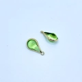 A pair of teardrop green crystal pendants with golden metal edging for jewelry making - Grass Green