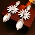 Silver flower teardrop earrings featuring sparkling rhinestones on a brown leather texture - Silver (Silver Pin) / Silver (HE16913)