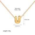 Detailed view of golden bubble letter U pendant with dimensions 10x8mm and 55cm chain - Letter U