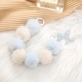 Light blue and beige faux fur ball wrist strap featuring a rainbow balloon dog charm - Light Blue Style (K940)