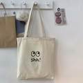 Bolso tote de lona color crema con gráfico de ojo negro y texto shh! estilo minimalista - Beige