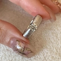 Close-up of a brushed white gold ring with a round zircon stone held against a plush background - Silver Brushed Craft Main Stone Round Open Ring (J5204)