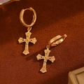 Macro shot of vintage gold-plated cross earrings with colorful zircon inlays on brown leather - KC Gold 8076 Vintage Gemstone Inlaid Gold Cross Earrings