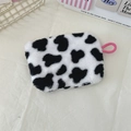 Close-up of cow print plush coin purse featuring a vibrant pink strap and fuzzy texture - Small Cow Print