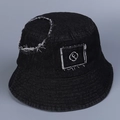 Detailed close-up of distressed denim fabric and letter f embroidery on black bucket hat - M(56-58cm) / Black