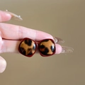 Close-up of vintage leopard print resin earrings with retro dark red border details - Red Square (Silver Earring Post)
