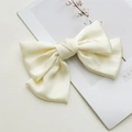 Close-up of a beige satin bow hair clip on a minimalist magazine background - Spring Clips / Beige