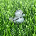 Polished green aventurine crystal duck figurine on artificial grass, natural gemstone carving - Kiwi