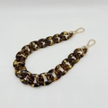 Macro detail of tortoiseshell acrylic chain links with golden lobster clasps accessory - Leopard Coffee