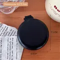 Mini spazzola per capelli pieghevole con specchio nera, design compatto per viaggio - Nero