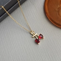 Exquisite gold necklace featuring double red heart pendants on a grey textured surface - Heart Cherry Necklace 0361