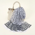 Lightweight black and white paisley print chiffon scarf draped by a beige handbag - White (Paisley Geometric)