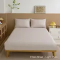 Solid light khaki fitted sheet and pillowcases in a minimalist bedroom setting - Light Khaki