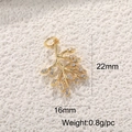 Macro shot of 22mm x 16mm gold branch pendant with cubic zirconia leaf details - Gold Branch